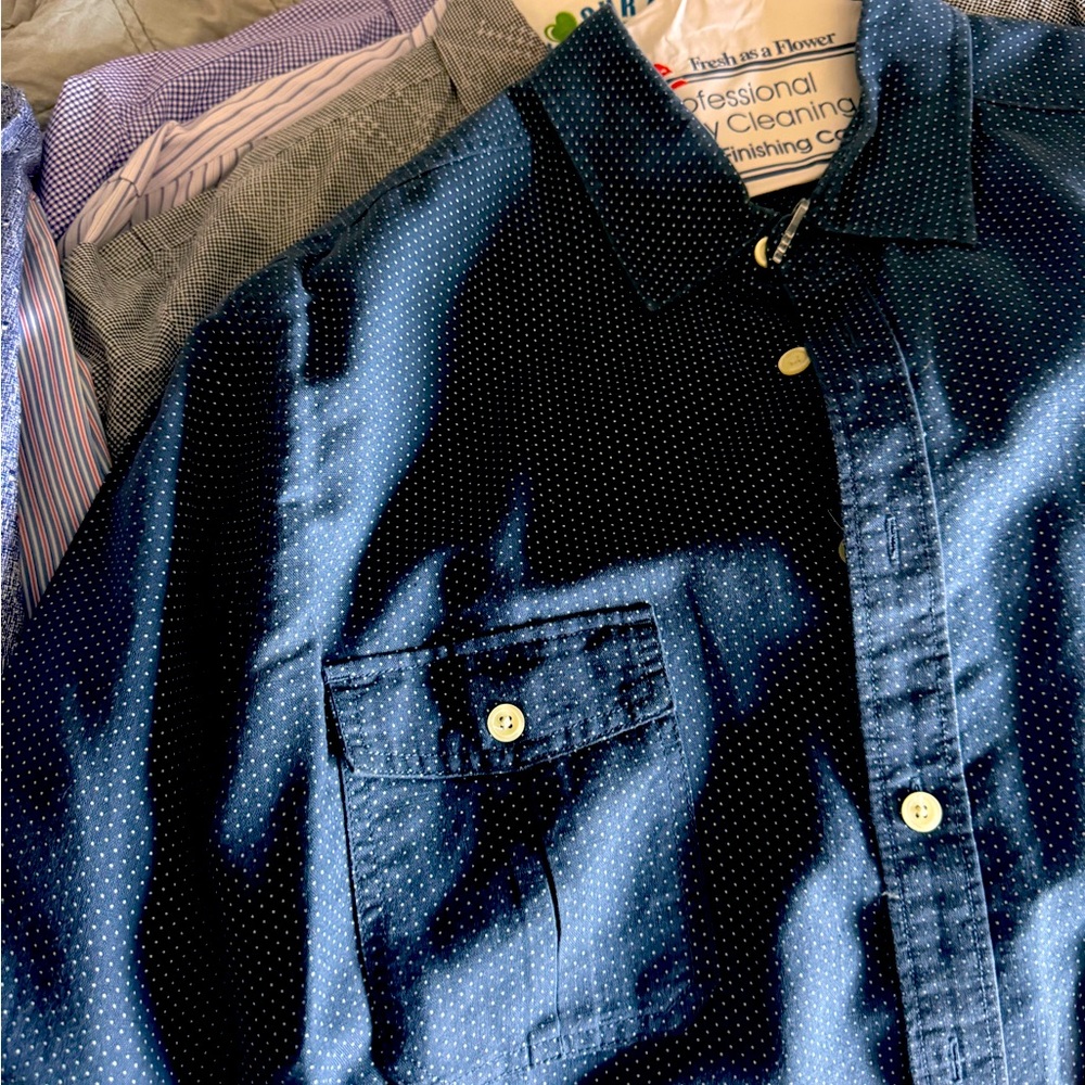 A bulk of men’s dress shirts hardly worn and all dry cleaned.